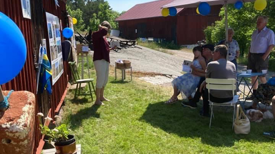 Sol, ballonger och kaffeservering på gräset utanför museet.