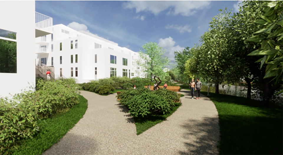 Vita hus bakom en grusgång, grönt gräs och buskar.