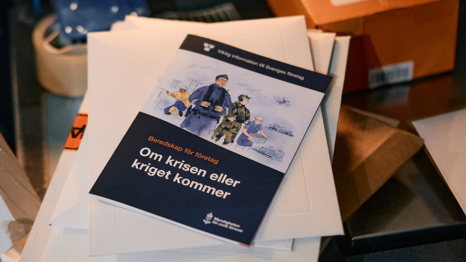 Broschyren ligger på en hög med papper.