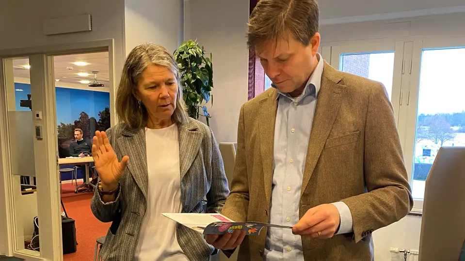 Skolchef Ann Bisenius samtalar med representant från Handelshögskolan, de tittar i en folder